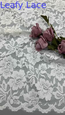 Full Width Stretch Lace Fabric In White, Adorned With Delicate Floral Patterns And Scalloped Edges Luxuriously